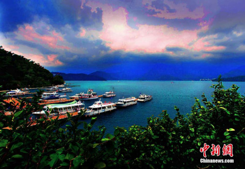 进入7月中旬夏暑假期的台湾日月潭风景旅游区游客剧增。称谓“天池”的日月潭，卧伏在玉山和阿里山之间的山头上，湖岸周长35公里，水域9平方公里多，最深处达三十米。夏季里，这处“青山拥碧水，明潭抱绿珠”的自然景区，吸引各地游客前来避暑观光。中新社记者 宋吉河摄