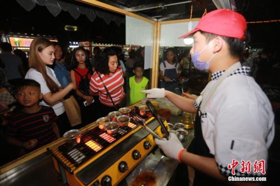 资料图 北体大武术生返乡摆摊卖“烤脑花”月入3万。中新社发 杨正华 摄 图片来源：CNSPHOTO